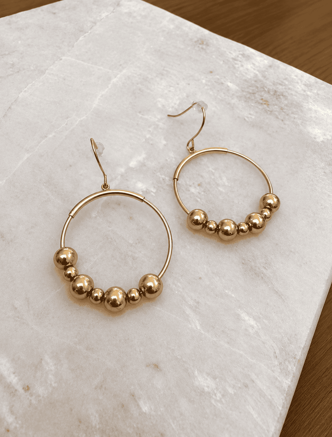 Sample Sale 29-Gold hoop earring with bead detail.